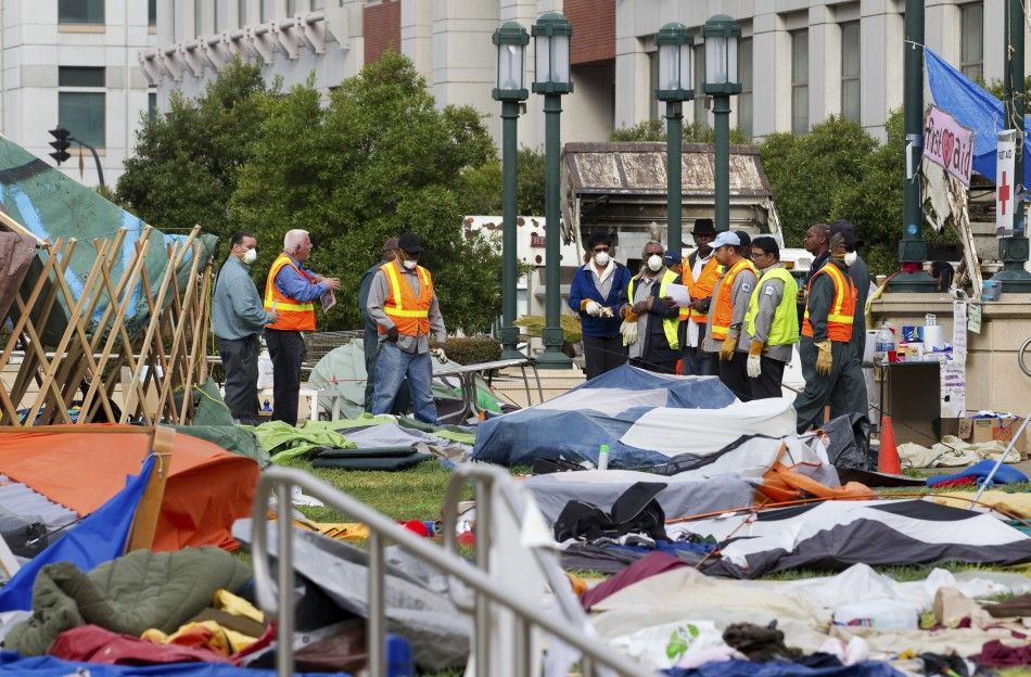 Workers prepare to clean up debris scattered throughout a closed-down camp of anti-Wall Street protesters in Oakland