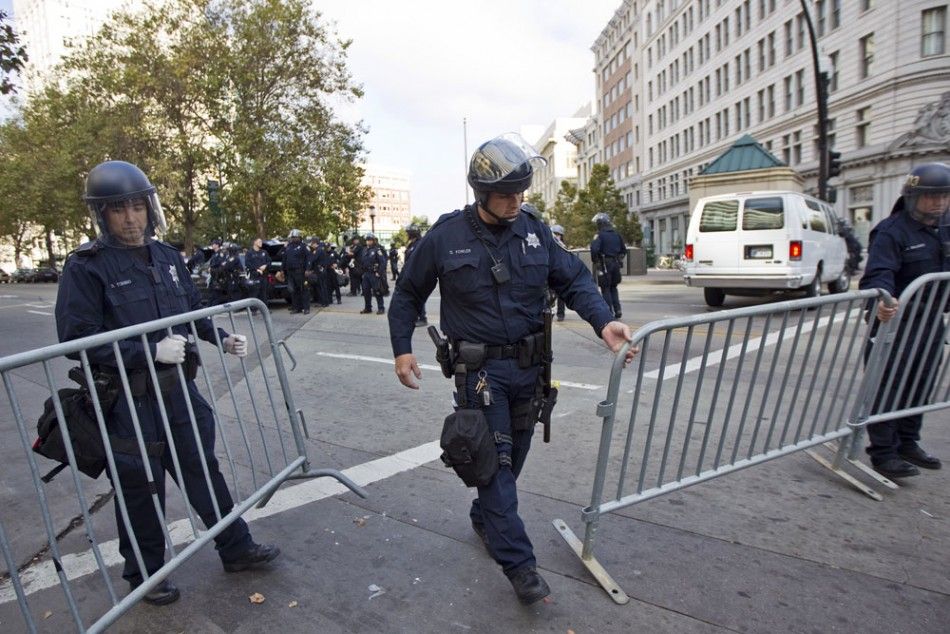 Policemen place barricades around a closed-down camp of anti-Wall Street protesters in Oakland