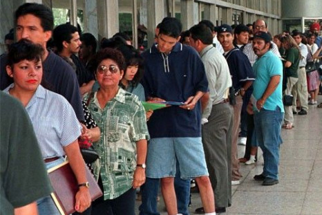 A group of immigrants, who qualify for residency in the United States but do not yet have their legal papers, stand in line at the Immigration and Naturalization Service offices in Los Angeles