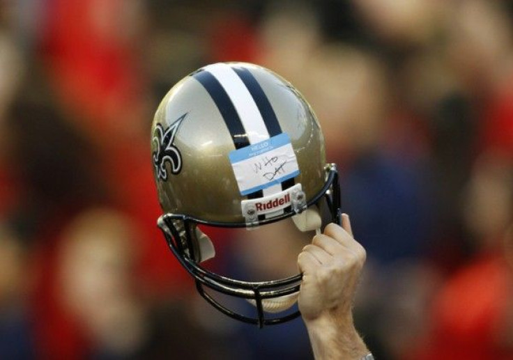 A member of the Saints staff holds up a helmet during the NFL's Super Bowl XLIV football game against the Indianapolis Colts in Miami