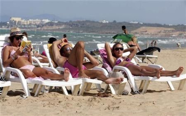 Tourists sunbathe on the beach in Tunisia