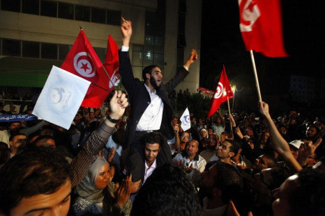 Supporters of the Islamist Ennahda movement celebrate outside Ennahda&#039;s headquarters in Tunis