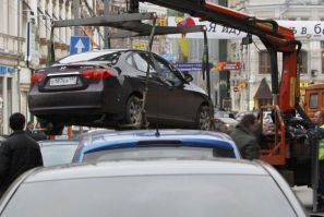 File photo of city authorities lifting a car parked on a pedestrian crossing before towing it away in Moscow. This is what I&#039;m always afraid will happen to my car in New York City. I have no reason to suspect that.