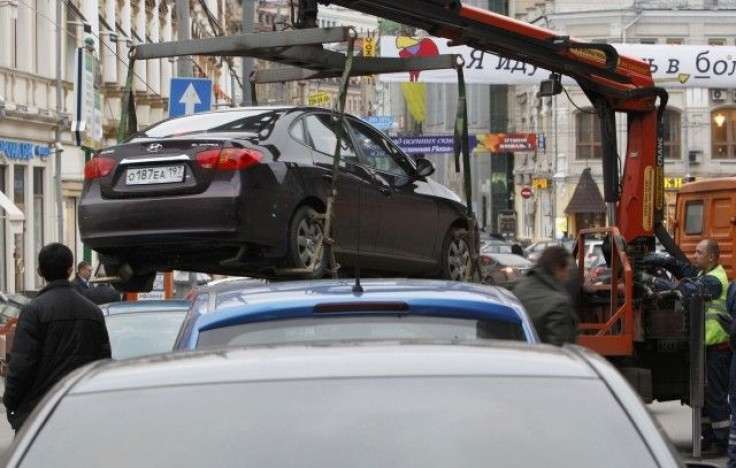File photo of city authorities lifting a car parked on a pedestrian crossing before towing it away in Moscow. This is what I&#039;m always afraid will happen to my car in New York City. I have no reason to suspect that.