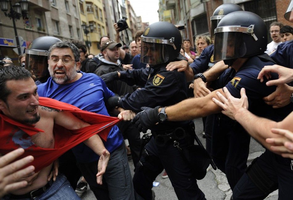 Stop Desahucios activists scuffle with police during a June 27 eviction in Oviedo, Spain