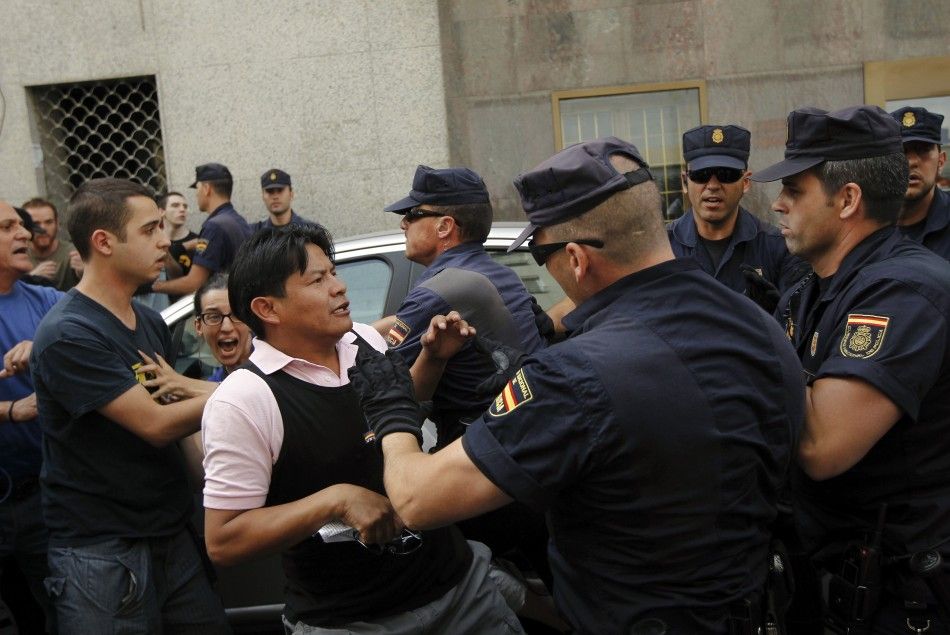 Demonstrators push back police trying to execute the June 27 evicition of Milagros Carbajo, in Madrid.