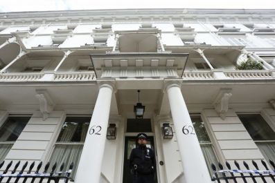 A policeman stands guard in front of the home of Eva Rausing in London