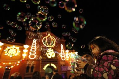 A girls shoots bubbles from a gun during the start of Diwali celebrations in Leicester