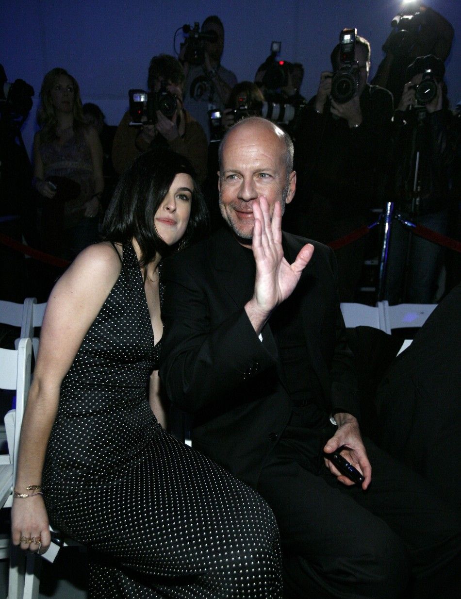 Bruce Willis sits next to his daughter Rumer at the GM Ten, General Motors annual fashion show in Hollywood