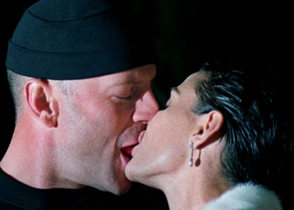 American actor Bruce Willis L kisses his wife Demi Moore R at the opening of one of their new ha..
