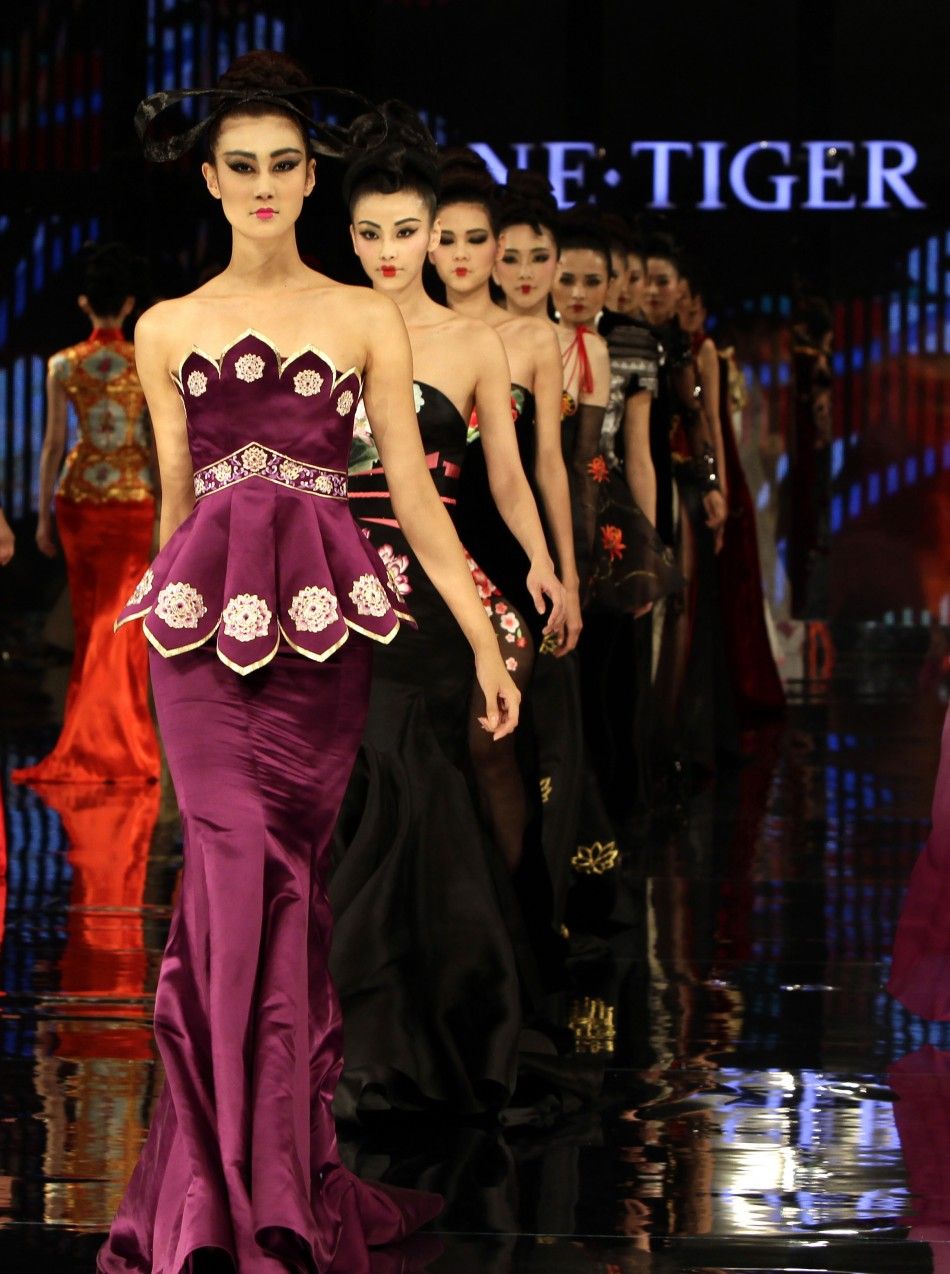 Models present creations for the NE TIGER 2012 Haute Couture collection with the theme quotTang Dynastyquot 618-907 during China Fashion Week for SpringSummer 2012 in Beijing October 25, 2011