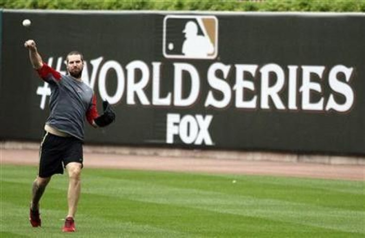 St. Louis Cardinals pitcher Chris Carpenter has a light workout in the rain at Busch Stadium after Major League Baseball cancelled Game 6 of the World Series in St. Louis, Missouri