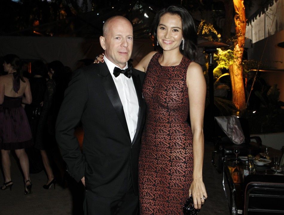 Actor Bruce Willis L and his wife Emma Heming pose at The Weinstein Company and Relativity Media039s after party for the 68th annual Golden Globe Awards in Beverly Hills, California January 16, 2011.