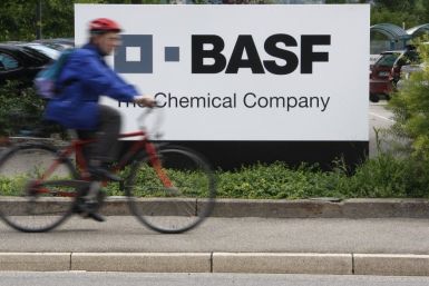 A cyclist rides his bike bast the entrance of the BASF plant in Schweizerhalle