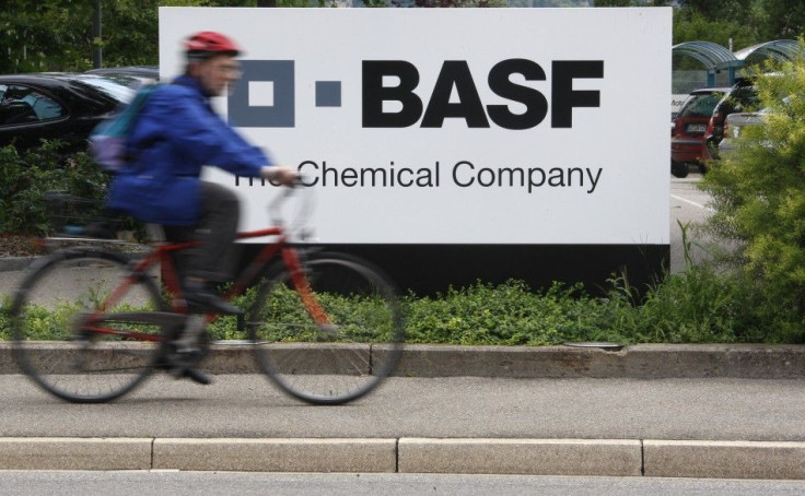 A cyclist rides his bike bast the entrance of the BASF plant in Schweizerhalle