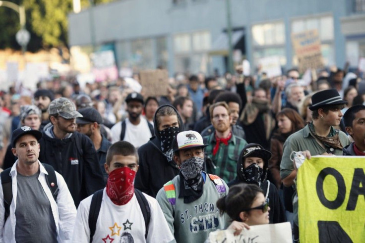 A group of "Occupy Wall Street" demonstrators walk toward Oakland City Hall in Oakland