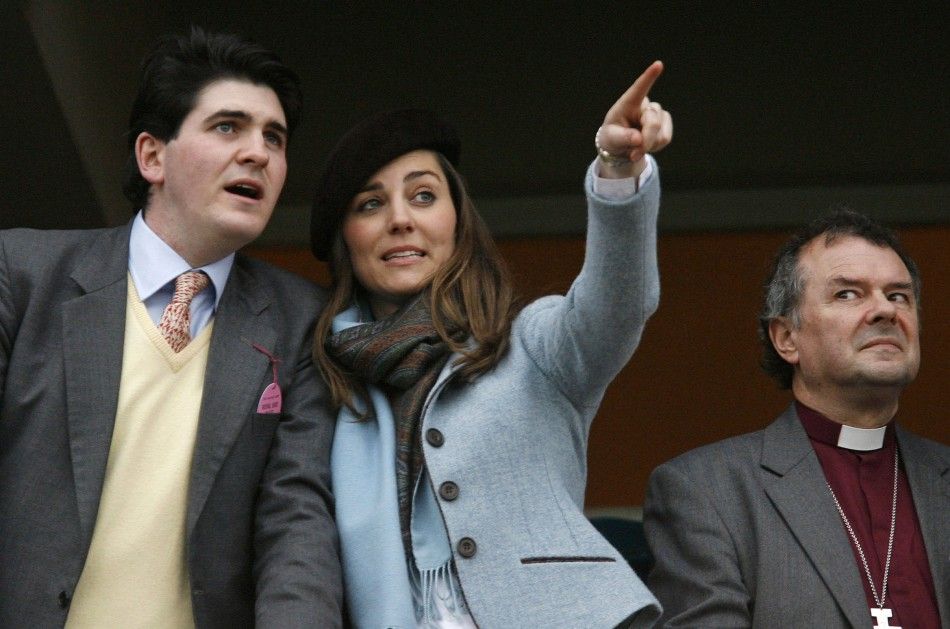 Middleton, girlfriend of Britains Prince William, and unidentified friend react while watching on the final day of the Cheltenham Festival