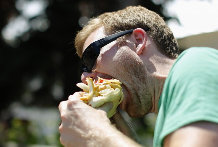 A man eats a hot dog