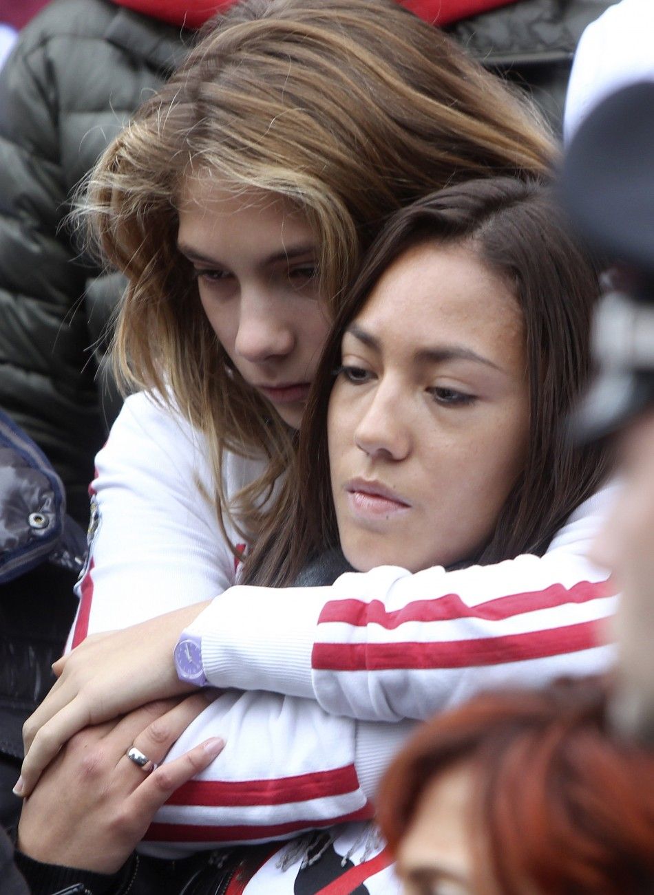 Honda MotoGP rider Marco Simoncellis sister Martina and girlfriend Kate react at the end of the funeral service in Coriano