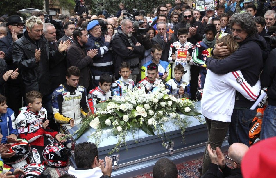 People clap at the end of the funeral service of Honda MotoGP rider Marco Simoncelli in Coriano