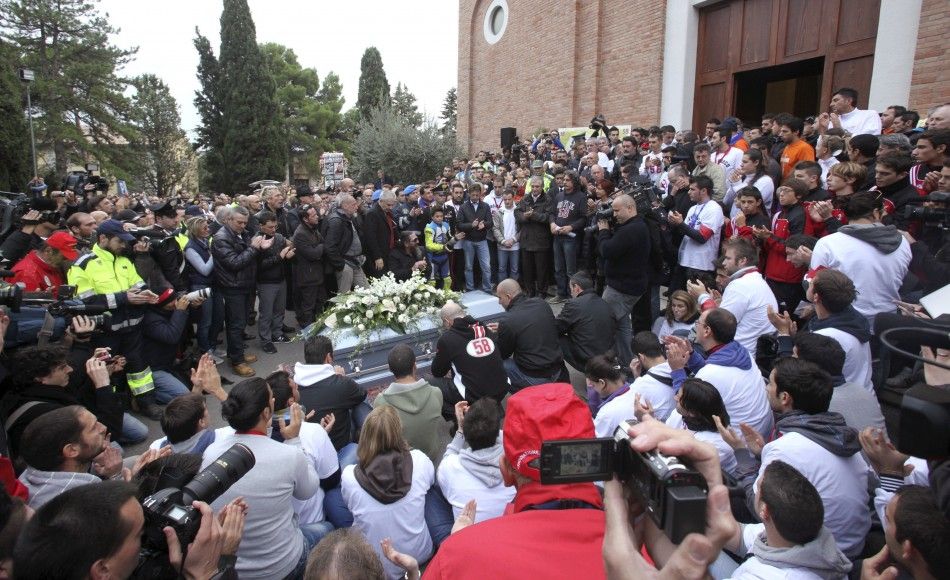 People clap at the end of the funeral service of Honda MotoGP rider Marco Simoncelli in Coriano