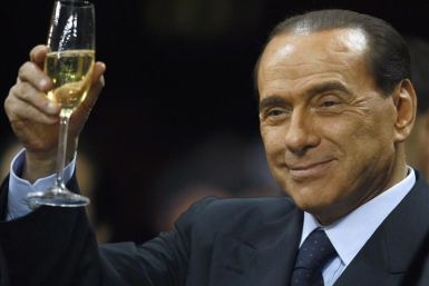 File photo of Italy&#039;s Prime Minister Berlusconi as he holds a glass of wine at San Siro stadium in Milan