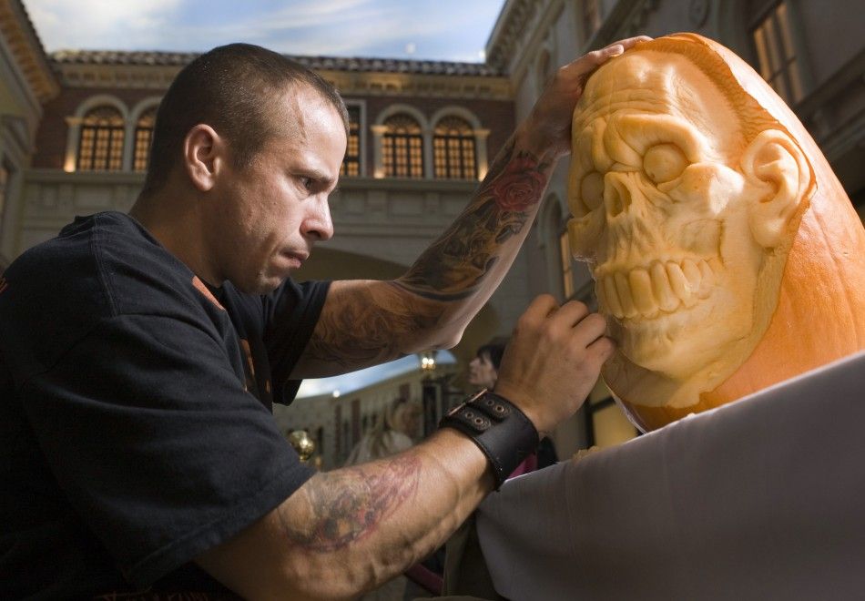 Artist Ray Villafane works on a pumpkin sculpture during an exhibition in the Grand Canal Shoppes at The Venetian hotel-casino in Las Vegas, Nevada October 26, 2011.