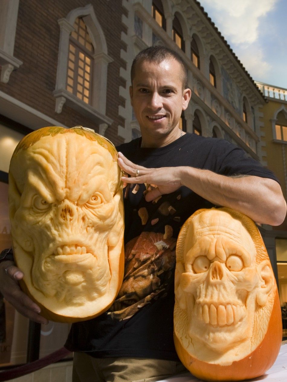 Ray Villafane poses with his pumpkins during a pumpkin carving exhibition in the Grand Canal Shoppes retail mall in Las Vegas