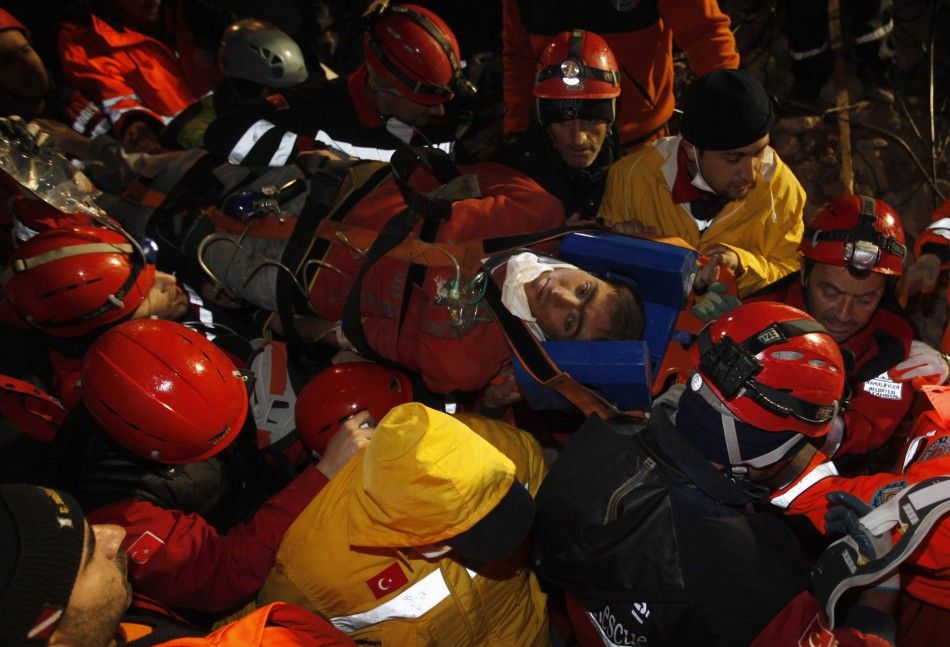 Rescue workers carry 18-year-old male survivor named Imdat from a collapsed building after surviving for more than 100 hours, in Ercis, near the eastern Turkish city of Van