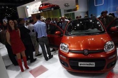 Models pose in front of a Fiat Panda during the International Motor Show (IAA) in Frankfurt