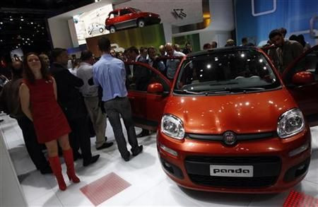 Models pose in front of a Fiat Panda during the International Motor Show (IAA) in Frankfurt