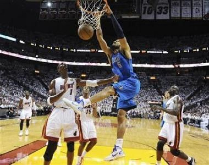 Dallas Mavericks center Tyson Chandler (6) dunks on Miami Heat forward Chris Bosh (1) in the first half during Game 6 of the NBA Finals basketball series in Miami