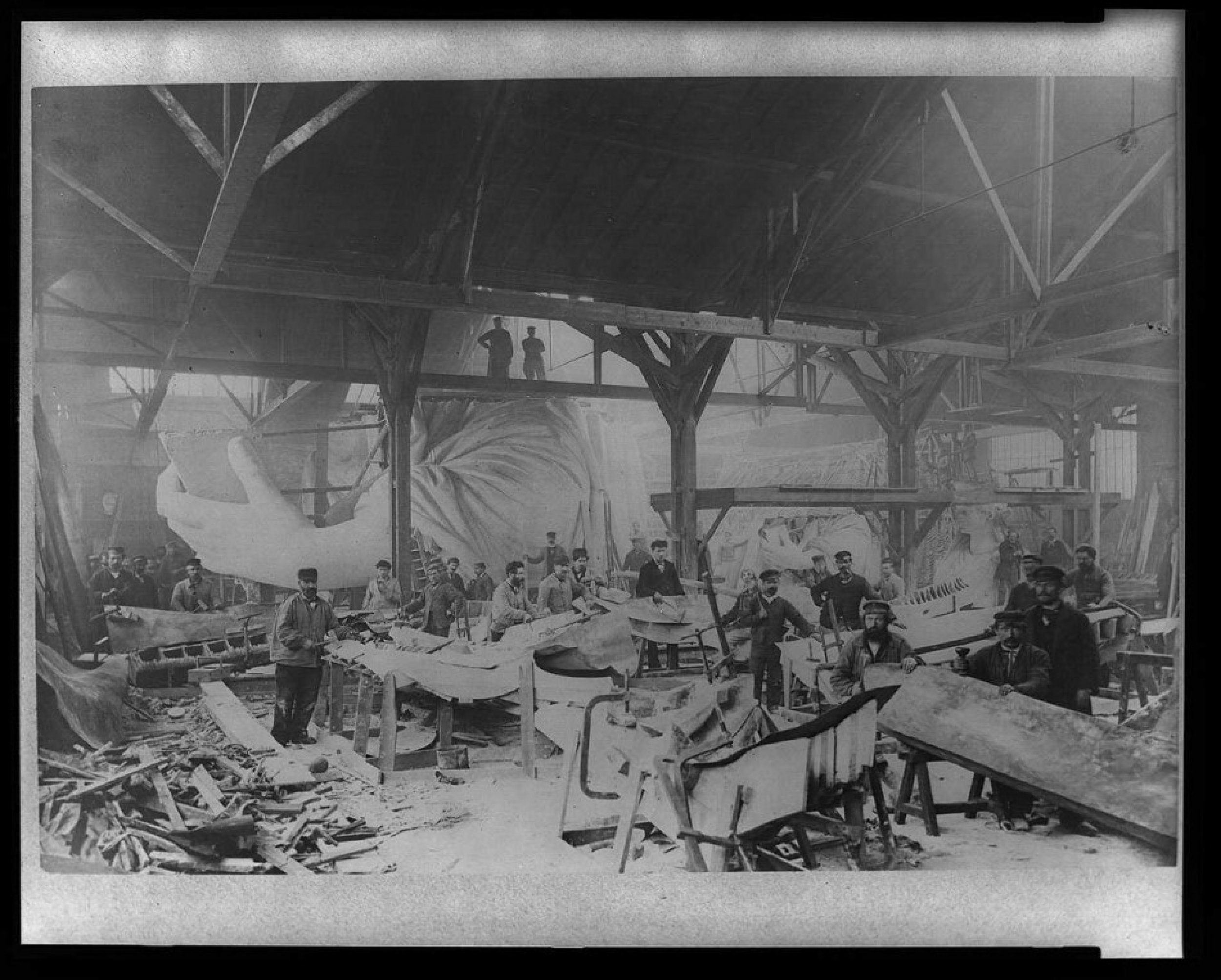 Workmen constructing the Statue of Liberty in Bartholdis Parisian warehouse workshop first model left hand and quarter-size head--Winter 1882