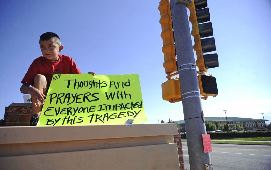 Brendon Hutchinson, 11, of Aurora, Colorado sits at the intersection north of the Century 16 theater shootings in Aurora,