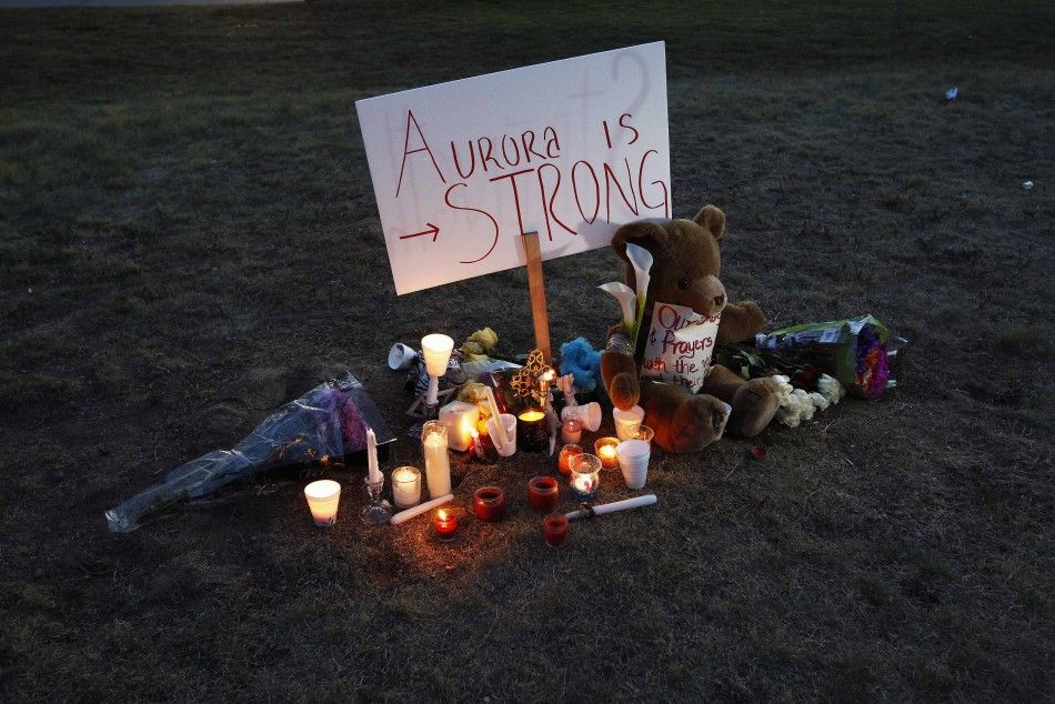 A sign is seen outside a vigil for victims behind the theater where a gunman opened fire in Aurora, Colorado  