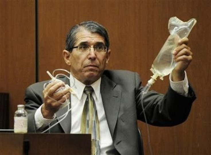Dr. Paul White, an anaesthesiologist and propofol expert, holds up an IV drip in the final stage of Dr. Conrad Murray&#039;s defense case, during Murray&#039;s involuntary manslaughter trial in Los Angeles