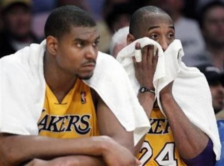 Los Angeles Lakers center Andrew Bynum (L) and guard Kobe Bryant (R) sit on the bench in the final minutes of a loss to the Dallas Mavericks during Game 2 of the NBA Western Conference semi-final basketball playoff in Los Angeles, California