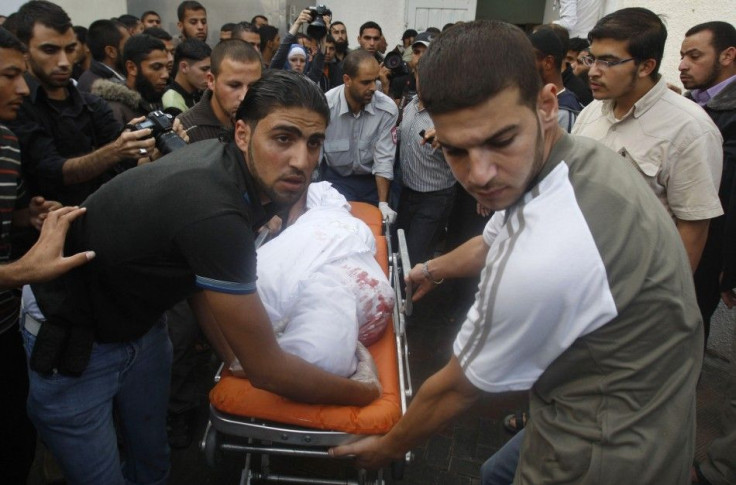Palestinians wheel the body of a militant killed in an Israeli air strike at a hospital in the Gaza Strip