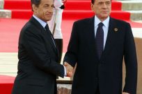 Berlusconi shakes hands with Sarkozy before the start of the G8 Summit in Deauville