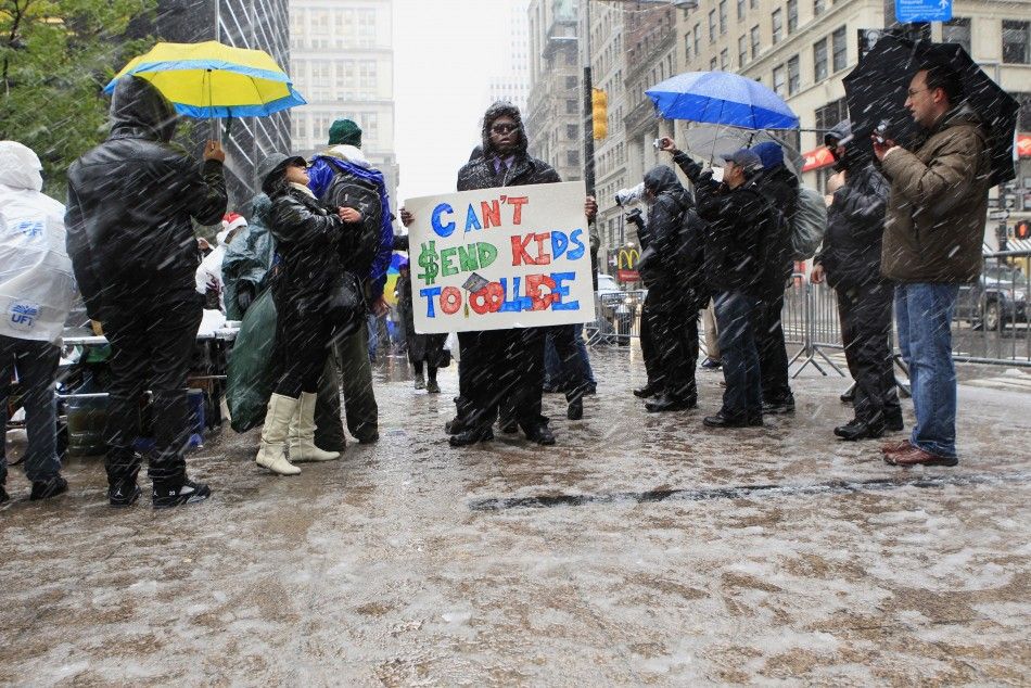 A member of the Occupy Wall Street movement demonstrates in Zuccotti Park during the first snow fall of winter in New York October 29, 2011.
