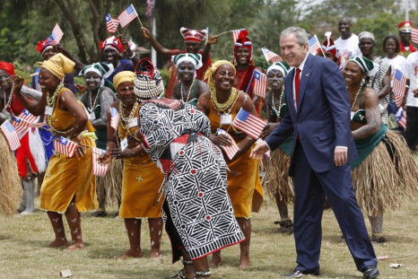U.S. President Bush dances with performers in Monrovia
