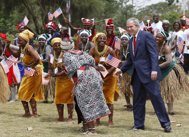 U.S. President Bush dances with performers in Monrovia