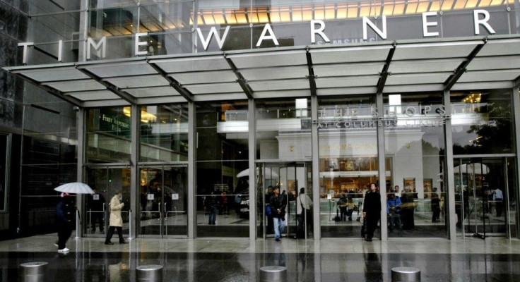 People walk in front of the Time Warner Inc. headquarters building at Columbus Circle in New York