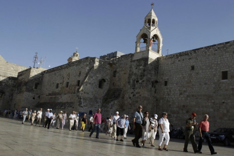 Holy Land tourists file past the Church of the Nativity, in the West Bank town of Bethlehem
