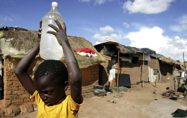 A boy carries a container of water in the suburb of Epworth in Zimbabwe&#039;s capital Harare