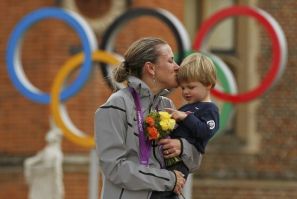 Gold medallist Kristin Armstrong of the U.S celebrates with her son Lucas William Savola on the podium during the victory ceremony of the women&#039;s cycling individual time trial at the London 2012 Olympic Games