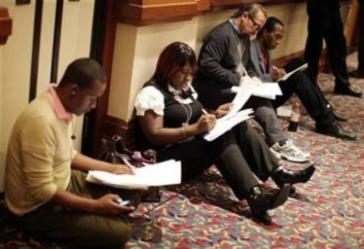 People fill up job application forms at a job fair in Los Angeles, California, October 13, 2010.  