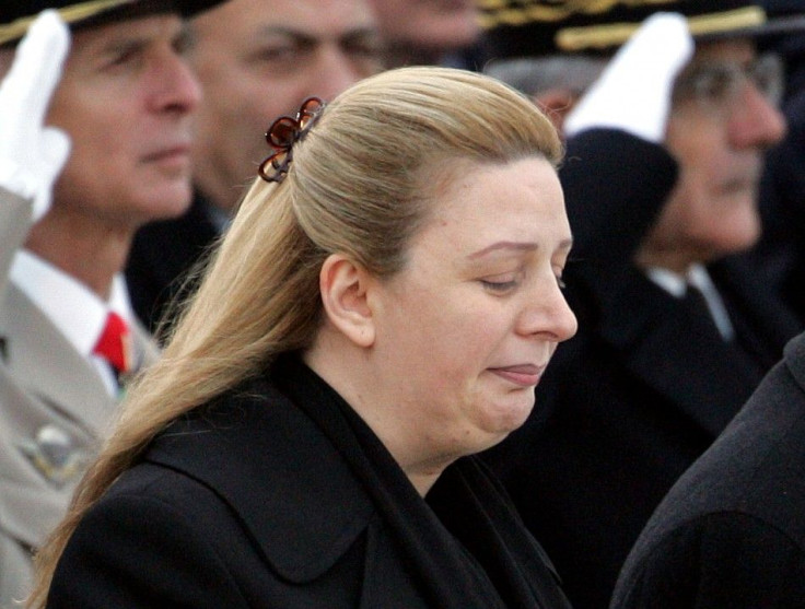 Suha Arafat waits while the coffin of her husband, Palestinian leader Yasser Arafat is loaded aboard.