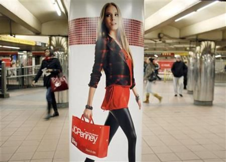 People walk past a JC Penney advertisement in a subway station in Manhattan New York