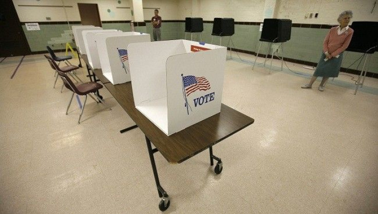 Election workers await voters during a lull at a polling station at Sleepy Hollow Elementary School in Falls Church, Virginia, November 4, 2008. 